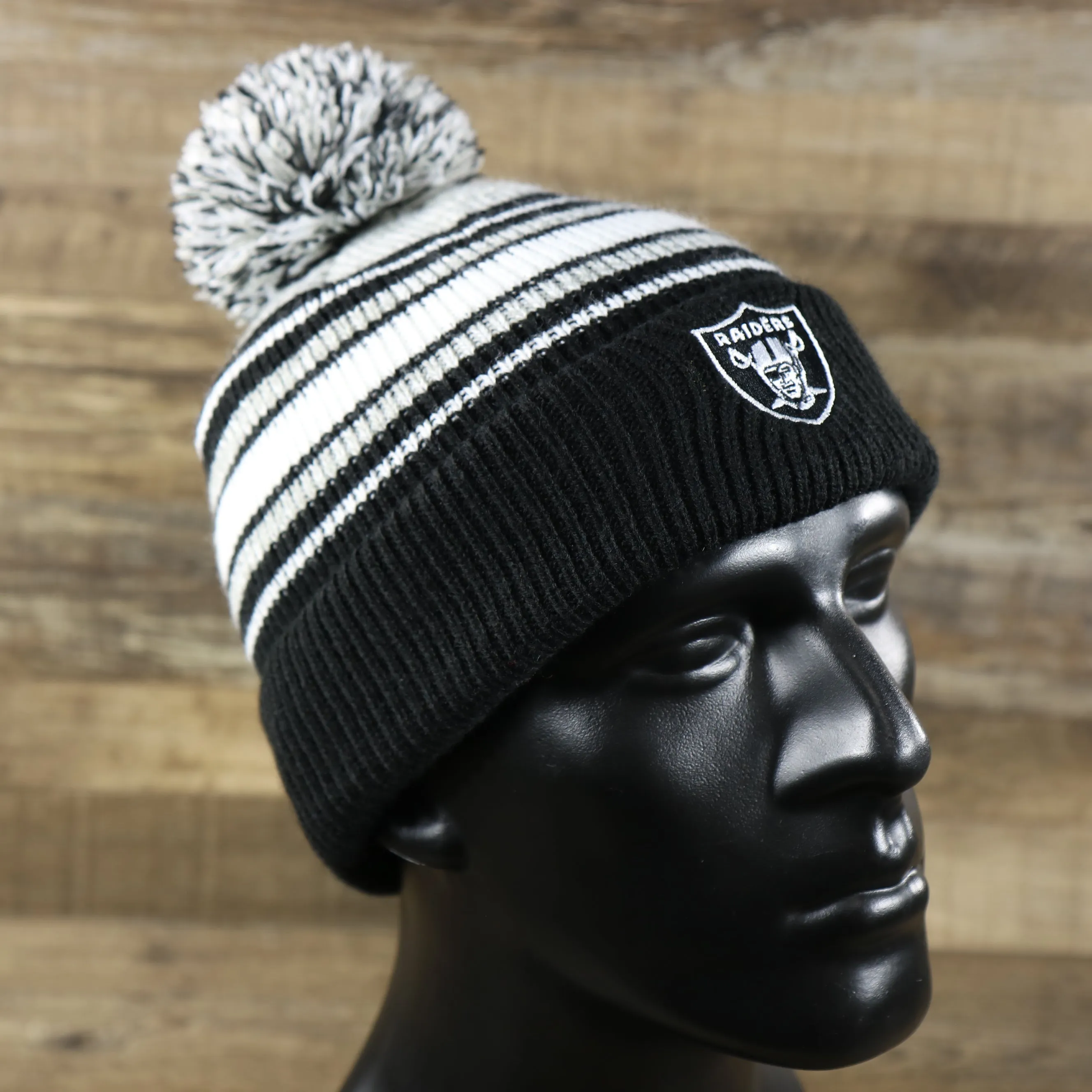 Kid's Oakland Raiders Winter Beanie - Striped Cuffed Black and Gray Hat with Pom Pom.