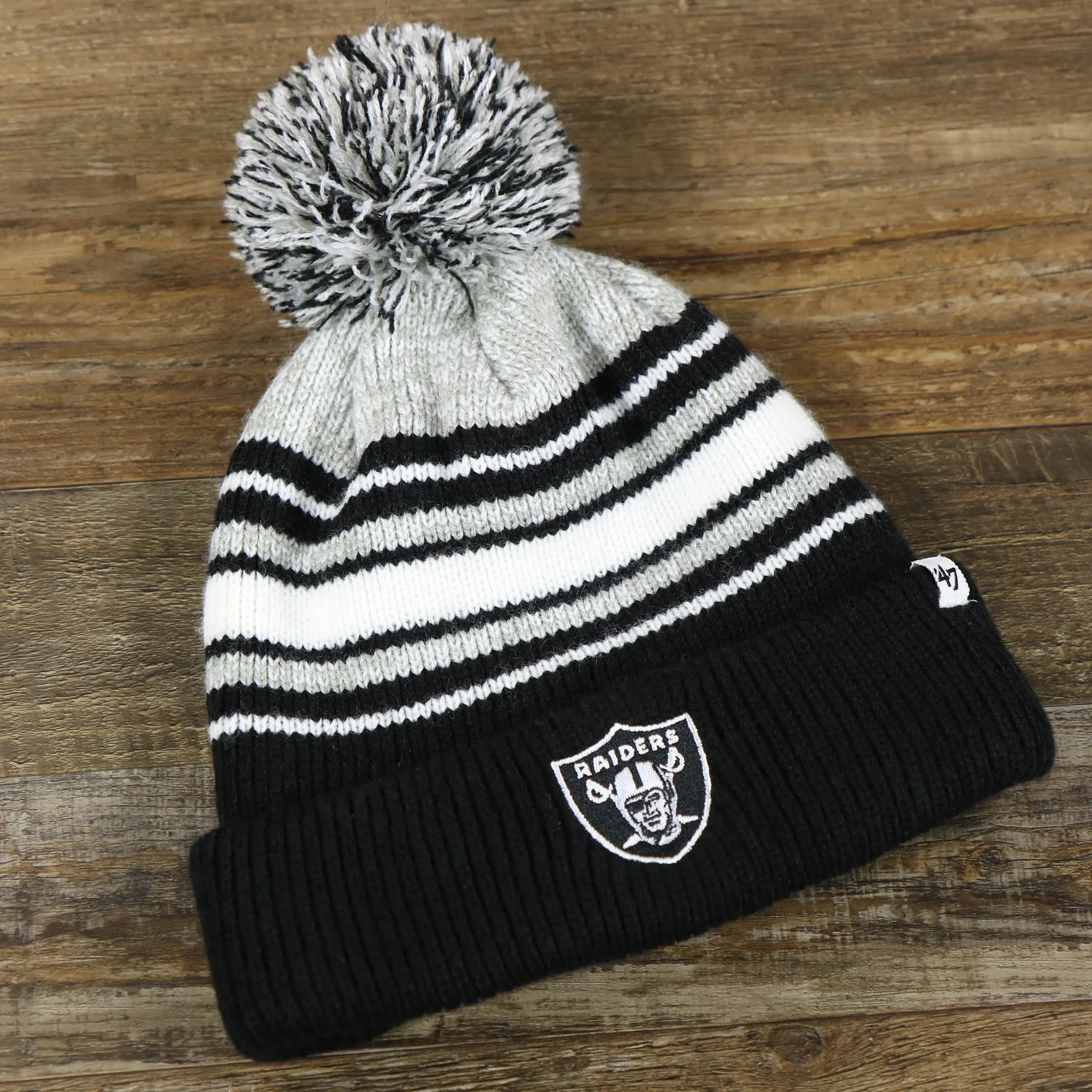 Kid's Oakland Raiders Winter Beanie - Striped Cuffed Black and Gray Hat with Pom Pom.