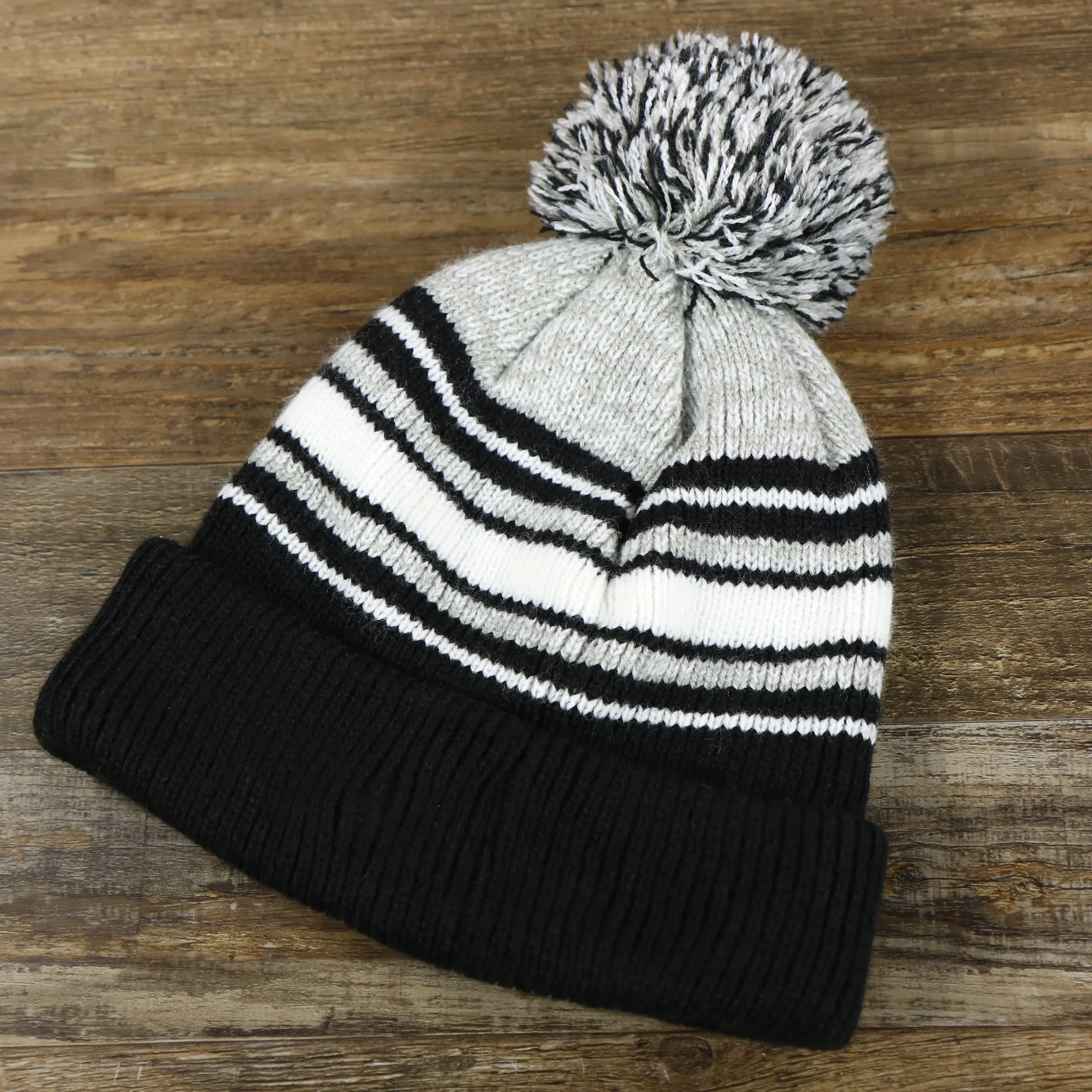 Kid's Oakland Raiders Winter Beanie - Striped Cuffed Black and Gray Hat with Pom Pom.