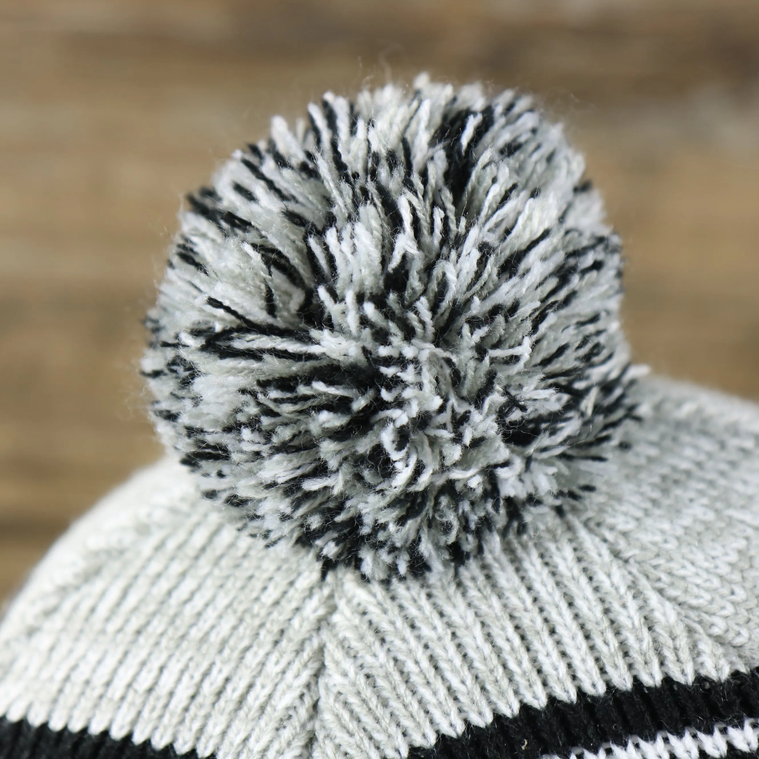 Kid's Oakland Raiders Winter Beanie - Striped Cuffed Black and Gray Hat with Pom Pom.